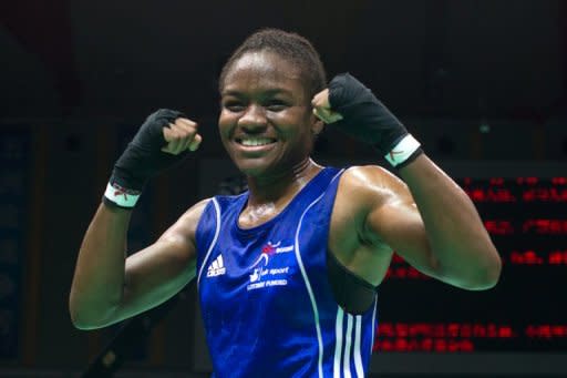 Nicola Adams of England gestures following her win against Elena Savelyeva of Russia during their flyweight semi-final bout at the Women's World Boxing Championships in China in May 2012. Her victory saved ensured she qualified for the Olympics