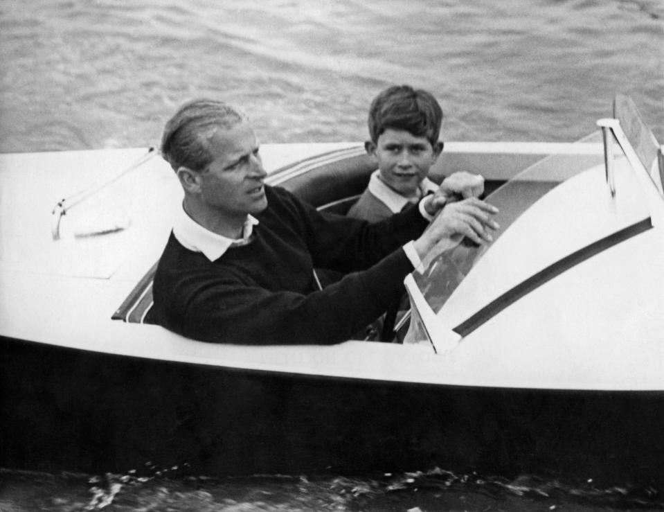 Prince Charles of Wales with his father Prince Philip of Edinburgh on board a boat, 1955AFP via Getty Images