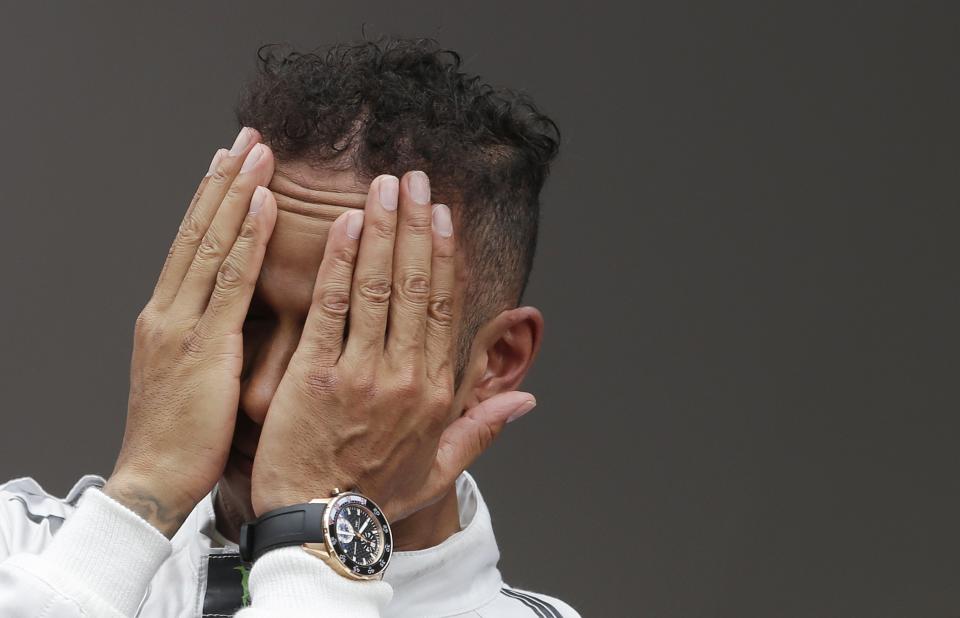 Mercedes Formula One driver Lewis Hamilton of Britain reacts on the podium after taking the second place in the Monaco Grand Prix in Monaco May 25, 2014. REUTERS/Max Rossi (MONACO - Tags: SPORT MOTORSPORT F1)