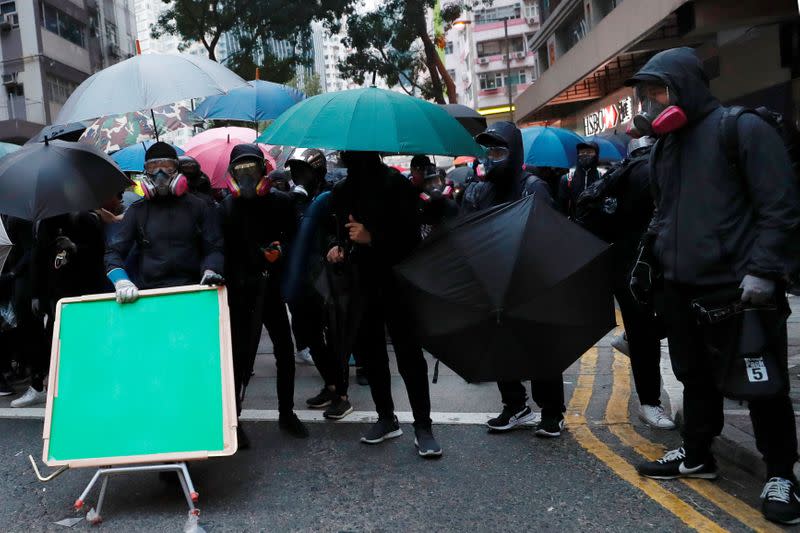 Anti-government protesters react as they standoff during a demonstration on the New Year’s Day to call for better governance and democratic reforms in Hong Kong