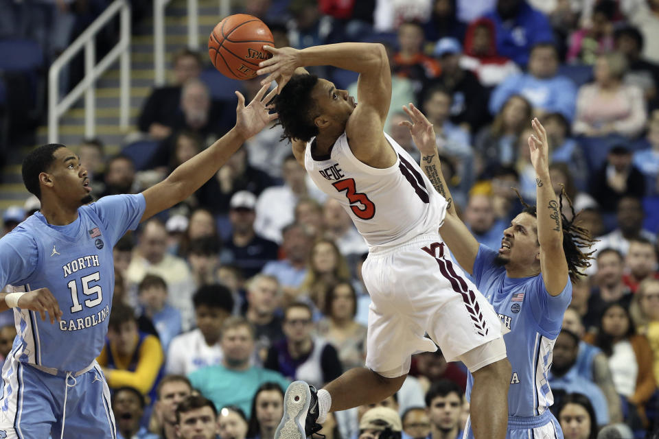 North Carolina forward Garrison Brooks (15) and guard Cole Anthony guard Virginia Tech guard Wabissa Bede (3) during the first half of an NCAA college basketball game at the Atlantic Coast Conference tournament in Greensboro, N.C., Tuesday, March 10, 2020. (AP Photo/Ben McKeown)