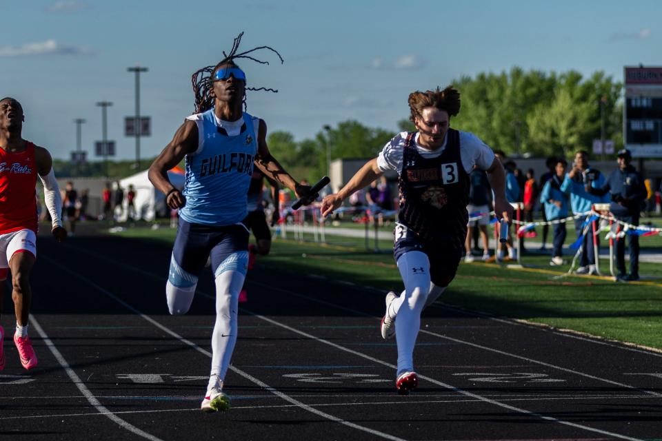 Guilford sprinter Messiah Tilson, middle, races to the finish line during the 4x100 relay at the boys NIC-10 conference meet on Friday, May 10, 2024, at Auburn High School.