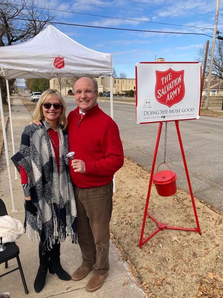 Shirley McCutchen, left, and Joey McCutchen, right, holds a bell he rang with volunteers for the Fort Smith Salvation Army Red Kettle Campaign Tuesday, Dec. 20, 2022 at his law office in north Fort Smith. Donations were down this year.