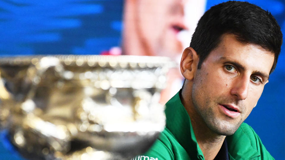Novak Djokovic (pictured) looking at the Australian Open trophy.