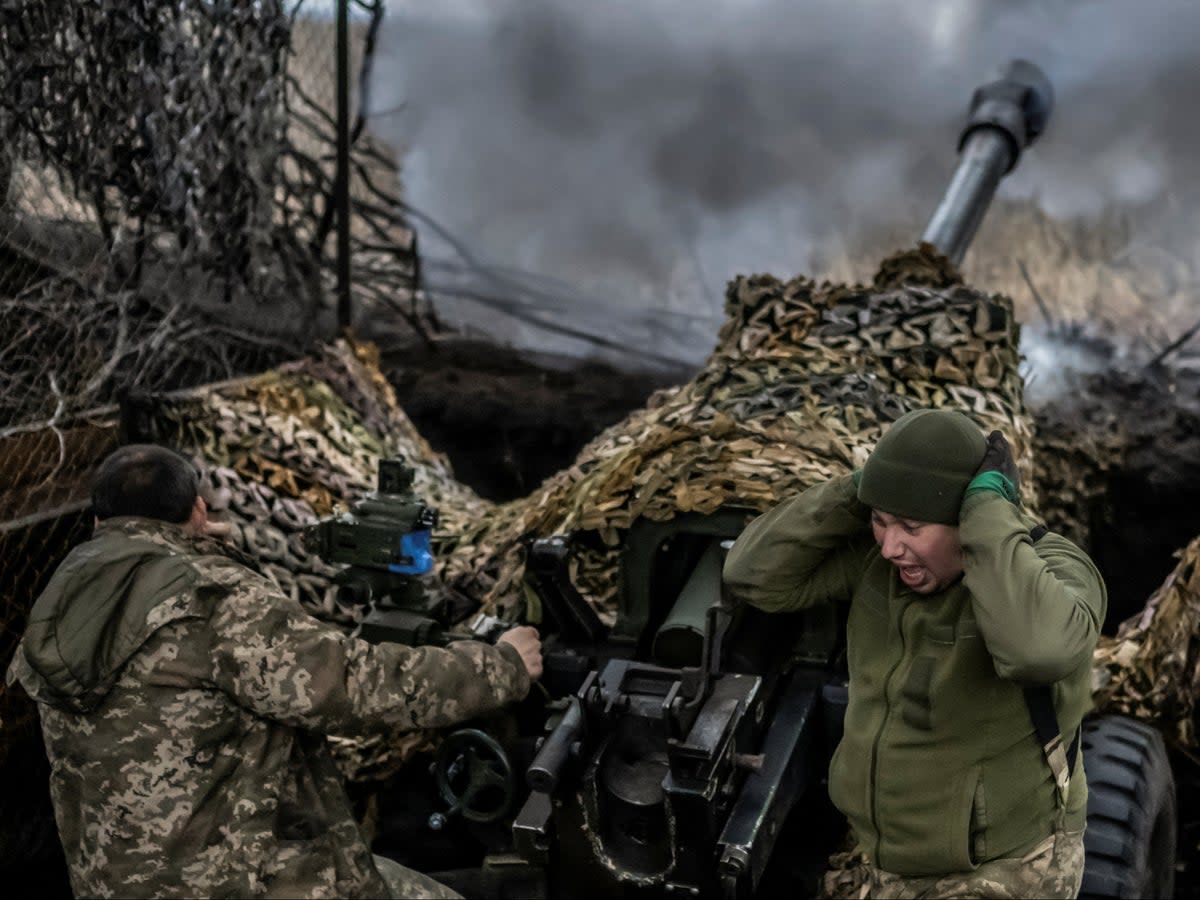 Ukrainian troops fire an L119 howitzer towards Russian forces, near the frontline town of Bakhmut  (Reuters)