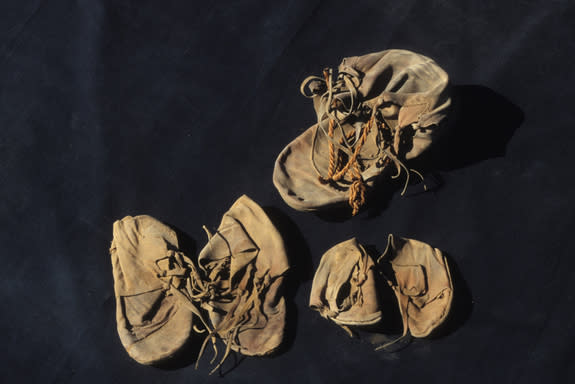 The unwrapped shoe bundle showing the two pairs of children's shoes and the adult isolate.