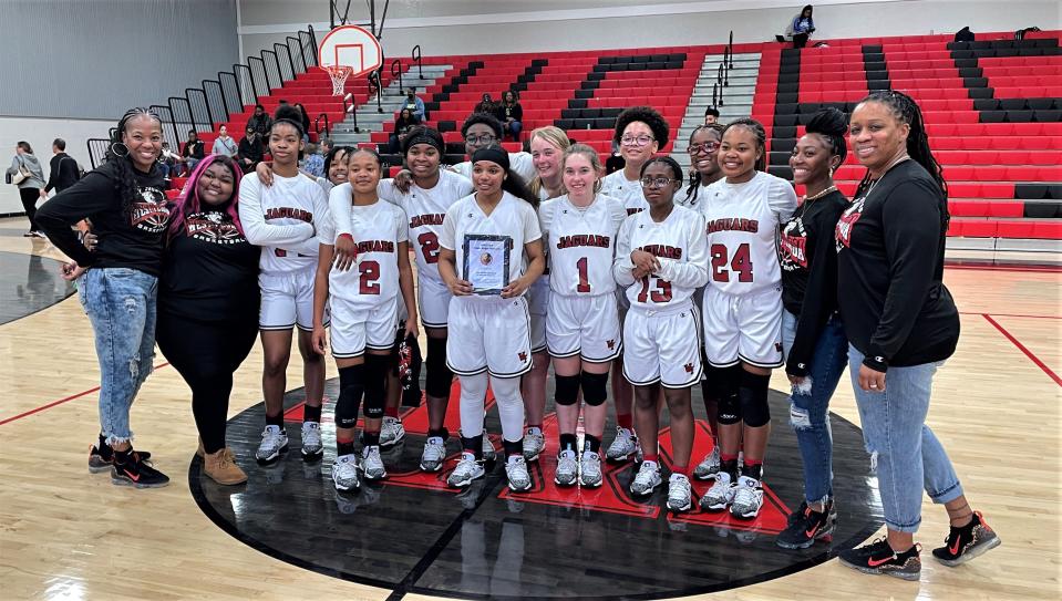 The West Florida girls basketball team poses for photos at midcourt following its 67-36 win against Baldwin County (Ala.) during the nightcap of the MLK Dreamkeeper Showcase on Jan. 16, 2023 from West Florida High School.