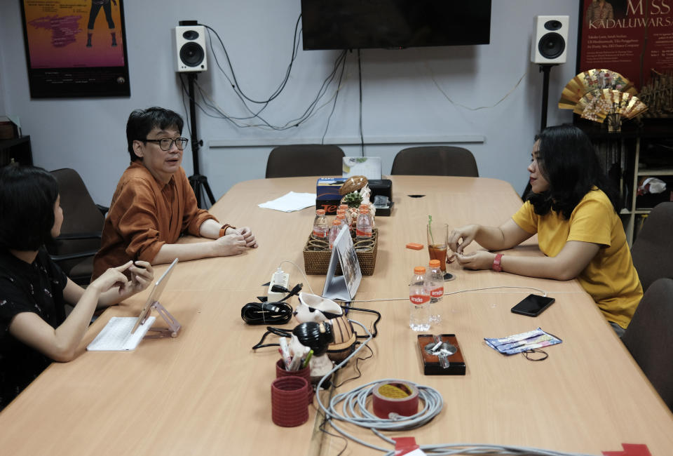 Indonesian choreographers Rusdy Rukmarata, left, and Yola Yulfianti talk during a meeting at Rukmarata's office in Jakarta, Indonesia Wednesday, May 13, 2020. Rukmarata and Yulfianti are helping fellow dancers who lost their jobs due to the new coronavirus outbreak in the country by setting up the YouTube channel as a platform where dancers, choreographers and dance teachers can perform, then receive donation from viewers. (AP Photo/Dita Alangkara)