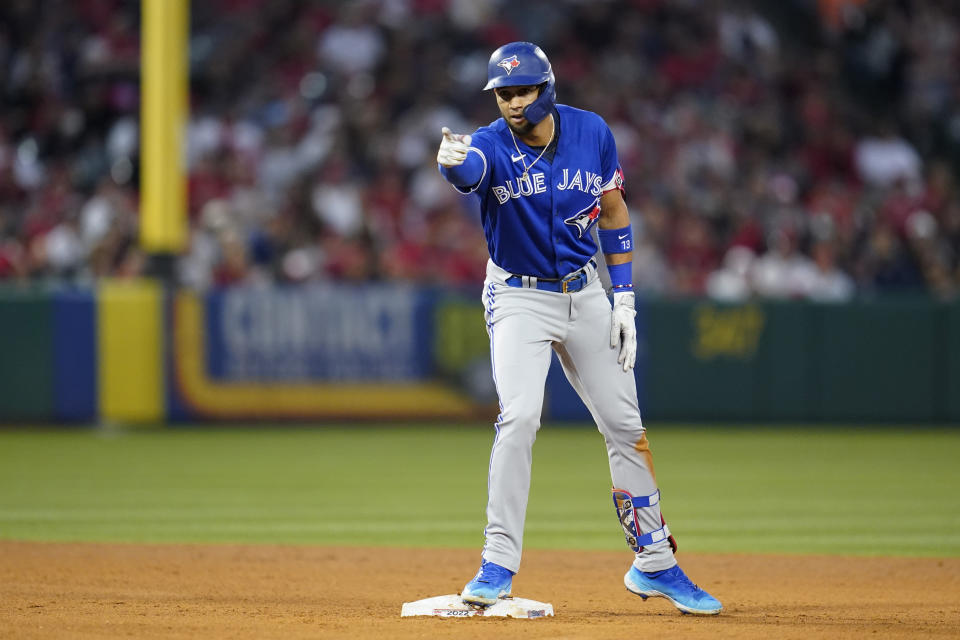 Toronto Blue Jays' Lourdes Gurriel Jr. (13) reacts after doubling during the fifth inning of a baseball game against the Los Angeles Angels in Anaheim, Calif., Friday, May 27, 2022. Andrew Kirk scored. (AP Photo/Ashley Landis)