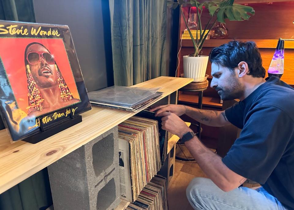 Sean Davidson, the Tecumseh man behind @vinyl_nights_, browses his record collection in his basement.