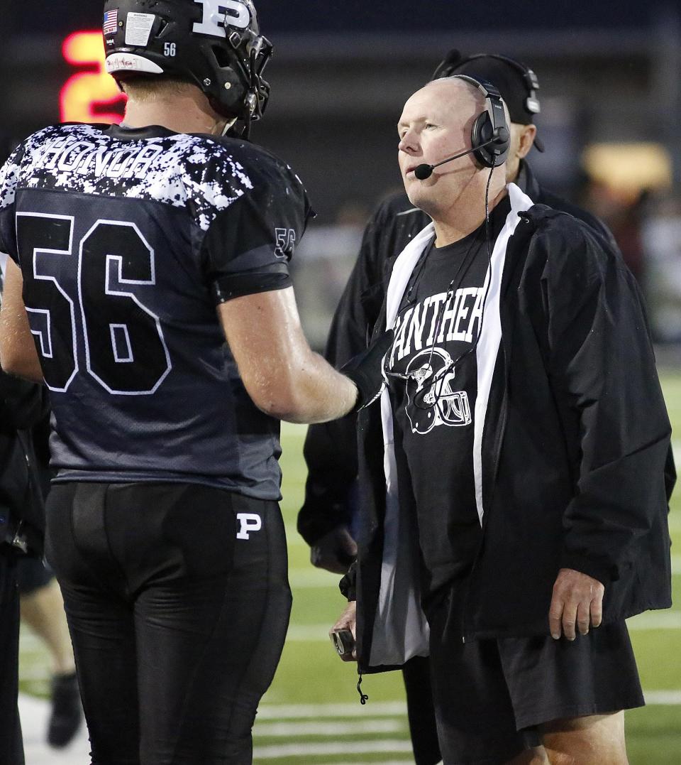 Matt Carrick (left) talks with Perry head coach Keith Wakefield.