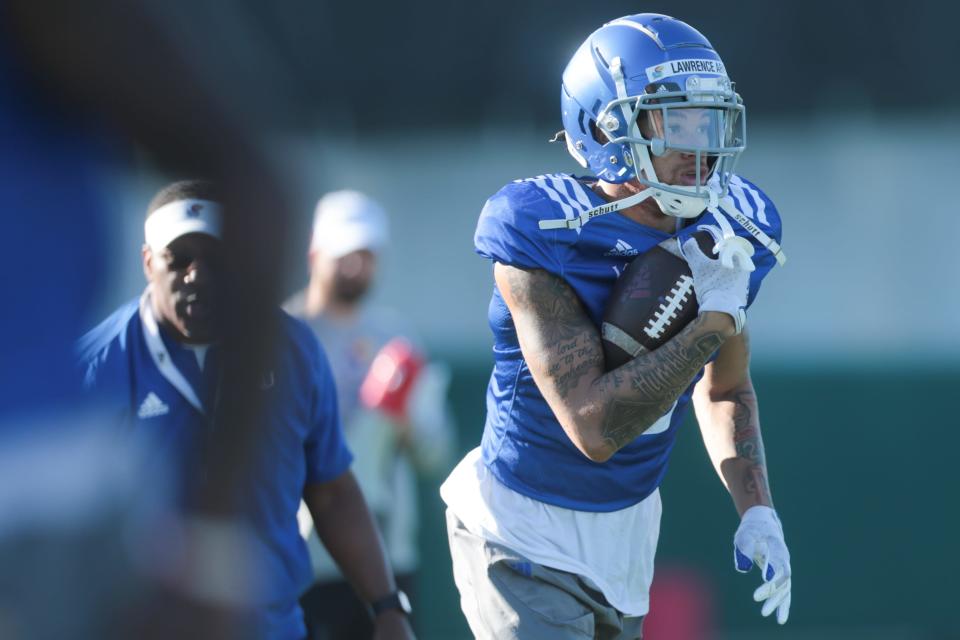 Kansas redshirt sophomore wide receiver Lawrence Arnold (2) runs through drills during practice Tuesday morning.