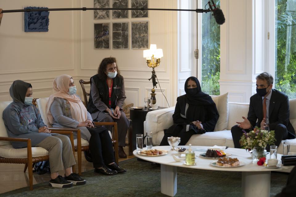 Afghan women attend a meeting with Greece's Prime Minister Kyriakos Mitsotakis at Maximos Mansion, in Athens, Friday, Oct. 15, 2021. The Afghan women, part of a group of judges, lawyers and lawmakers who fled Afghanistan following the Taliban takeover, meet with the Greek Prime Minister before they reach their final destination in the United States. (AP Photo/Petros Giannakouris)