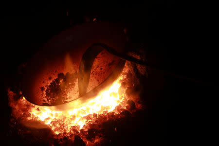 A wok is seen inside a forge at a workshop for handmade woks in Datian village, Hubei province, China August 13, 2018. REUTERS/Thomas Suen