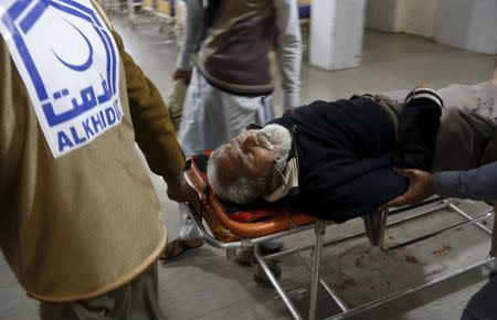 Rescue workers move a man who sustained injuries in a suicide attack at a government office, to Lady Reading Hospital in Peshawar, Pakistan, December 29, 2015. REUTERS/Khuram Parvez