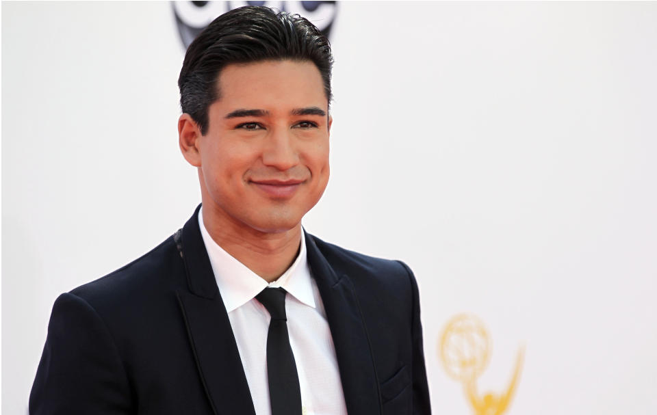 FILE - In this Sept. 23, 2012 file photo, Mario Lopez arrives at the 64th Primetime Emmy Awards at the Nokia Theatre, in Los Angeles. “Extra” host, Mario Lopez and “Keeping Up with the Kardashians," co-star, Khloe Kardashian Odom, will host the second season of the Fox talent competition, "The X-Factor." The network said Tuesday, Oct. 16, 2012, that Odom and Lopez will first appear as hosts during the show's live broadcasts beginning this November. (Photo by Matt Sayles/Invision/AP, File)