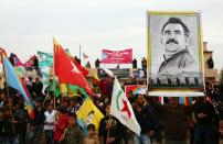 Kurdish protesters hold a portrait of Kurdistan Worker's Party jailed leader Abdullah Ocalan on February 14, 2016, during a rally in the northeastern Syrian city of Qamishli to mark the 17th anniversary of his arrest by Turkish agents
