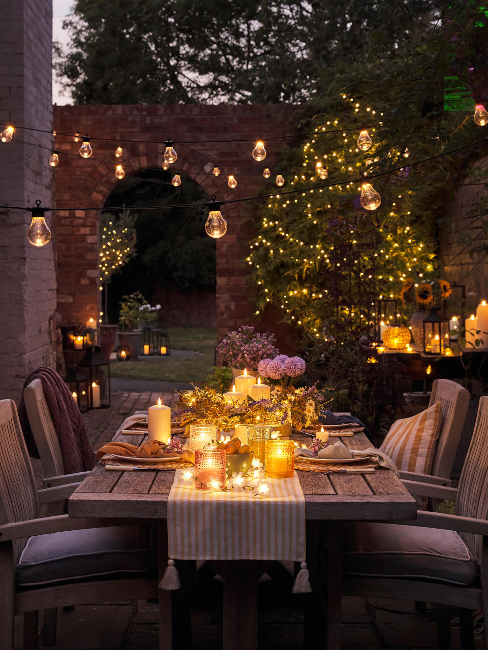 <p> Outdoor string lighting are a great complement to cottage patio ideas and can be easily hung from a rustic pergola. Let them drape towards the table for a soft effect and gentle light for the tabletop. Team them with other light sources for sufficient illumination for the patio area.&#xA0; </p>