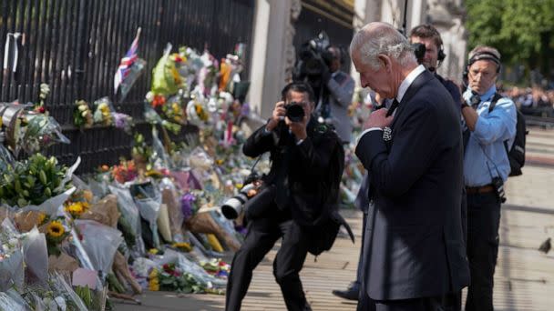 PHOTO: King Charles III reads messages left by mourners at the gates of Buckingham Palace in London, Sept. 9, 2022. (Kirsty Wigglesworth/AP)