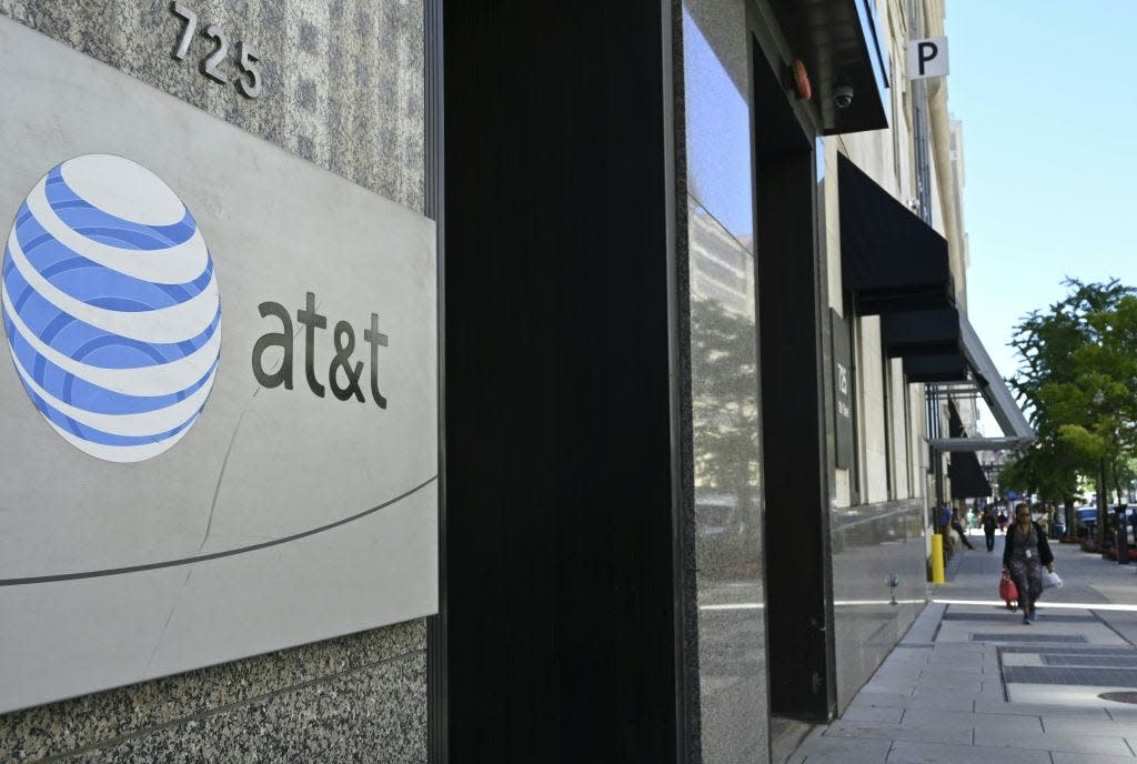 An AT&T telecommunication logo is seen at the entrance of a building in Washington, D.C. on June 11, 2019.