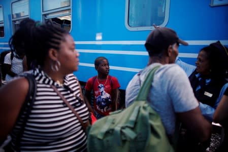 A boy listens to instructions prior embarking on Cuba's Chinese-made first new passenger train cars at La Coubre train station in Havana