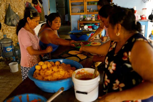 PHOTO: Women prepare food during celebrations for The Faithful Departed in the town of Buena Vista close to where the new Mayan train route is being built, in Bacalar, Quintana Roo, Mexico, November 8, 2022. (Jose Luis Gonzalez/Reuters)