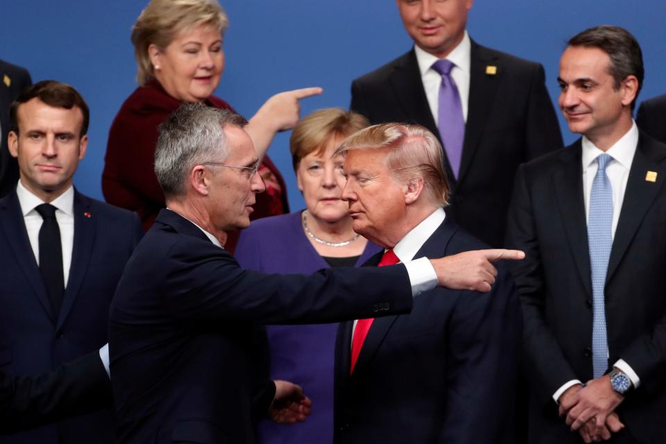 In this Dec. 4, 2019, file photo, NATO Secretary-General Jens Stoltenberg, front left, speaks with U.S. President Donald Trump, front right, after a group photo at a NATO leaders meeting at The Grove hotel and resort in Watford, Hertfordshire, England.