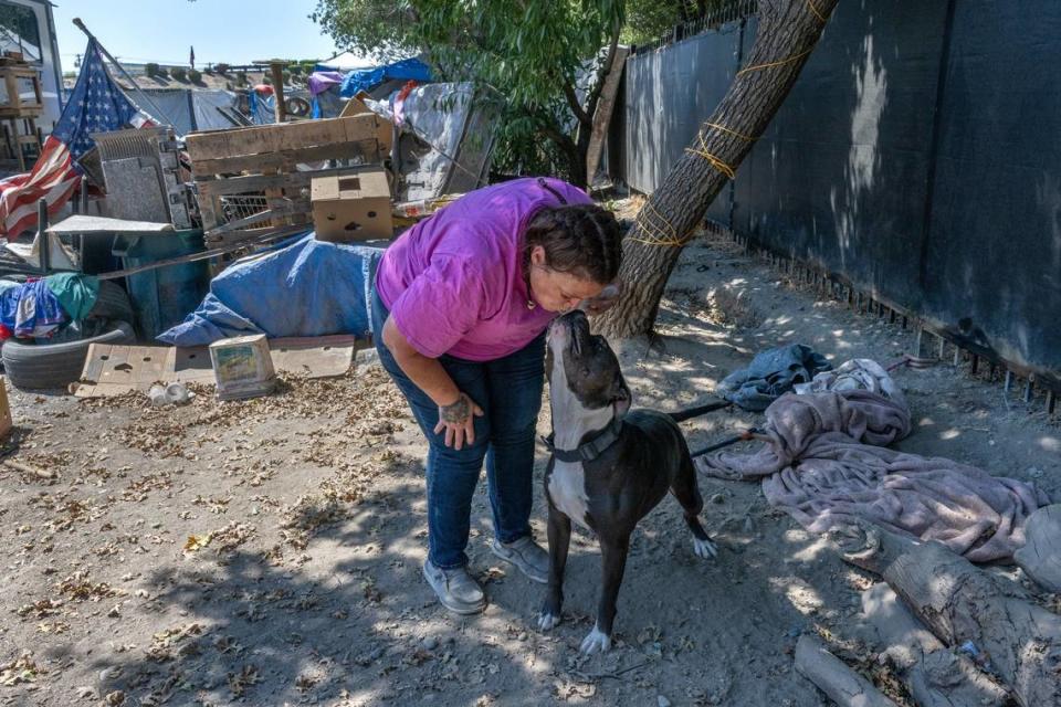 Tamitha Myler, 55, kisses her dog Rescue at Camp Resolution in August.