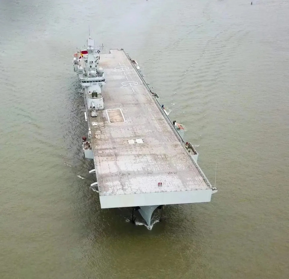 For comparison, a look down the deck of the first Type 075 during its initial sea trials. The ship's stern aircraft elevator, as well as the one it has in the middle of the deck, are visible <em>Chinese Internet</em>