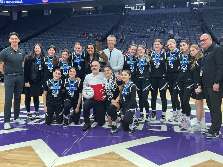 The Shalhevet girls basketball team celebrates after winning a state championship.