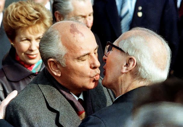 PHOTO: Soviet Leader Mikhail Gorbachev and his wife, Raisa, are welcomed by East German Leader Erich Honecker with a fraternal kiss in East Berlin, October 6, 1989. (Reuters)