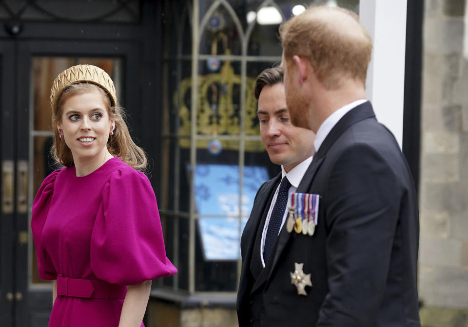 Britain's Prince Harry, Princess Beatrice and Edoardo Mapelli Mozzi arrive at Westminster Abbey ahead of the coronation of King Charles III and Camilla, the Queen Consort, in London, Saturday, May 6, 2023. (Andrew Milligan/Pool via AP)