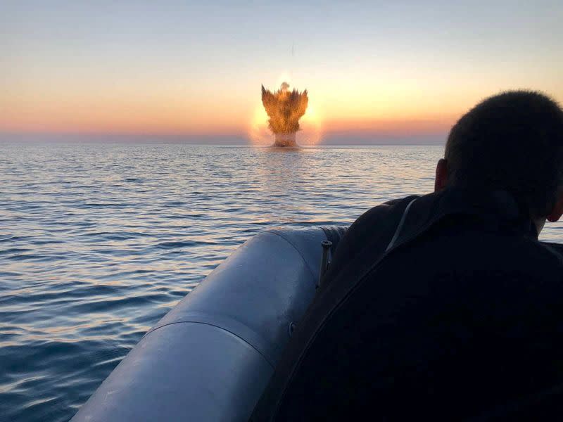 Bulgarian navy personnel destroy a naval mine in the Black Sea