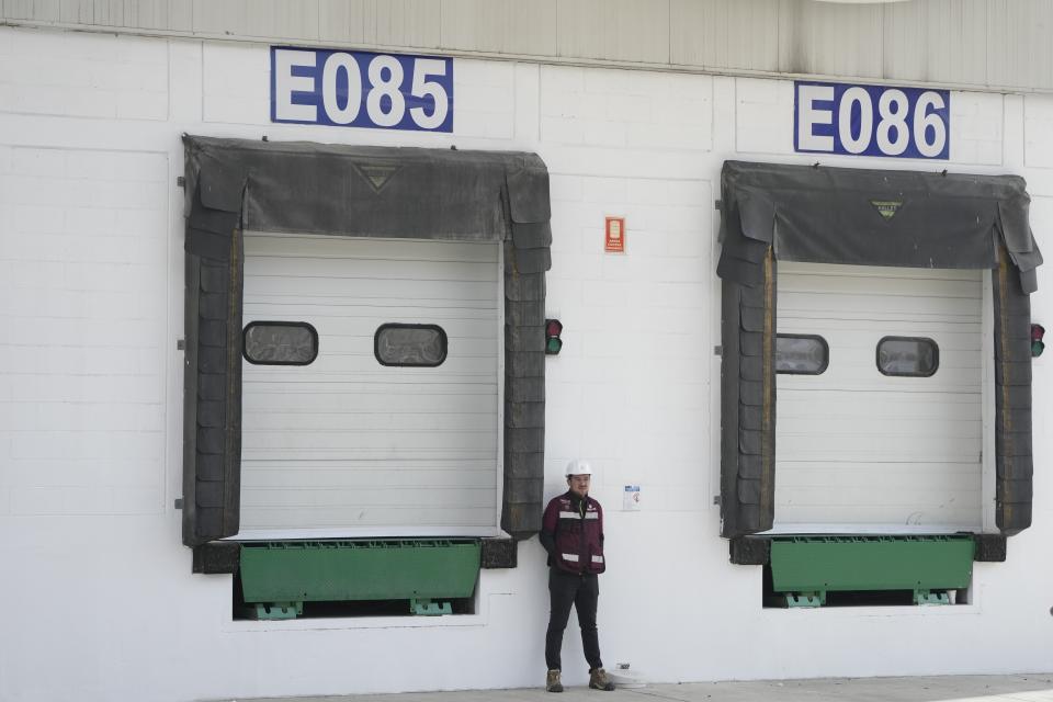 A worker stands in the cargo area of a mega-pharmacy warehouse on its inauguration day in Huehuetoca, Mexico, Friday, Dec. 29, 2023. It is Mexican President Andres Manuel Lopez Obrador's solution to help end a supply issue for hospitals that don't have specific medicines needed by patients. (AP Photo/Fernando Llano)