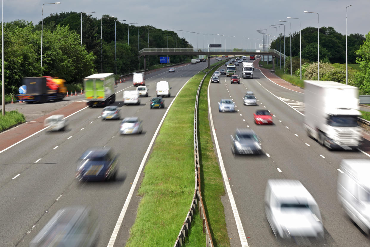 Heavy traffic moving at speed on the M6 motorway in England