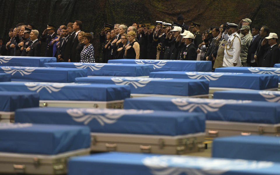 Attendees salute during a repatriation ceremony for the remains of U.S. soldiers who were killed in the Korean War and collected in North Korea, at the Osan Air Base in Pyeongtaek, South Korea, Wednesday, Aug. 1, 2018. North Korea handed over 55 boxes of the remains last week as part of agreements reached during a historic June summit between its leader Kim Jong Un and U.S. President Donald Trump. (Jung Yeon-je/Pool Photo via AP)