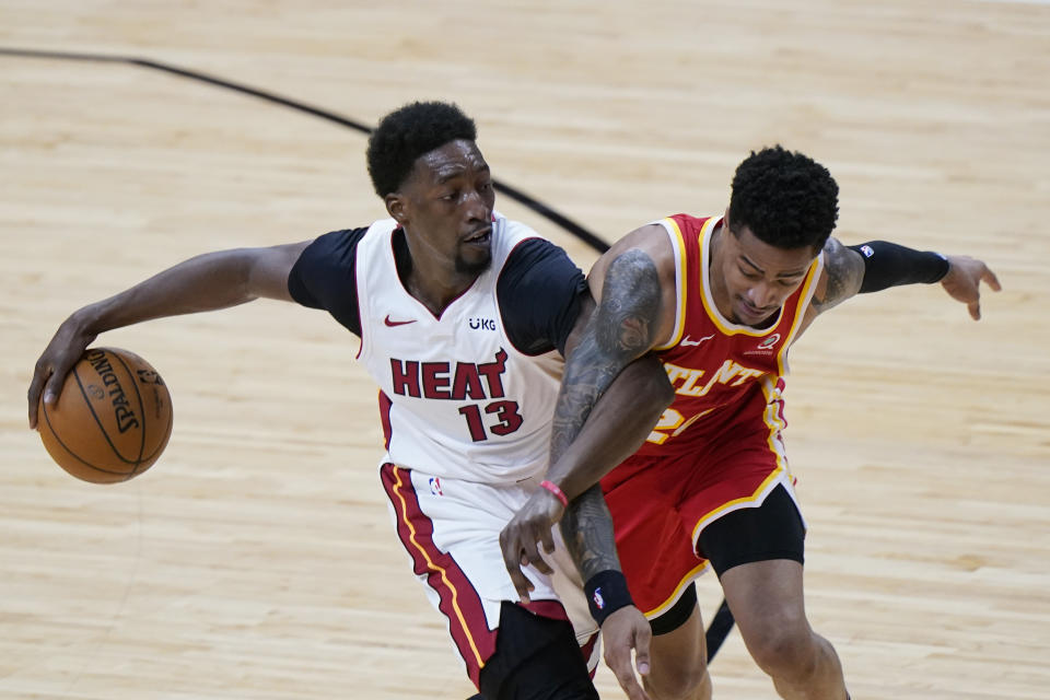 Miami Heat center Bam Adebayo (13) drives to the basket against Atlanta Hawks forward John Collins (20) during the second half of an NBA basketball game, Tuesday, March 2, 2021, in Miami. (AP Photo/Wilfredo Lee)