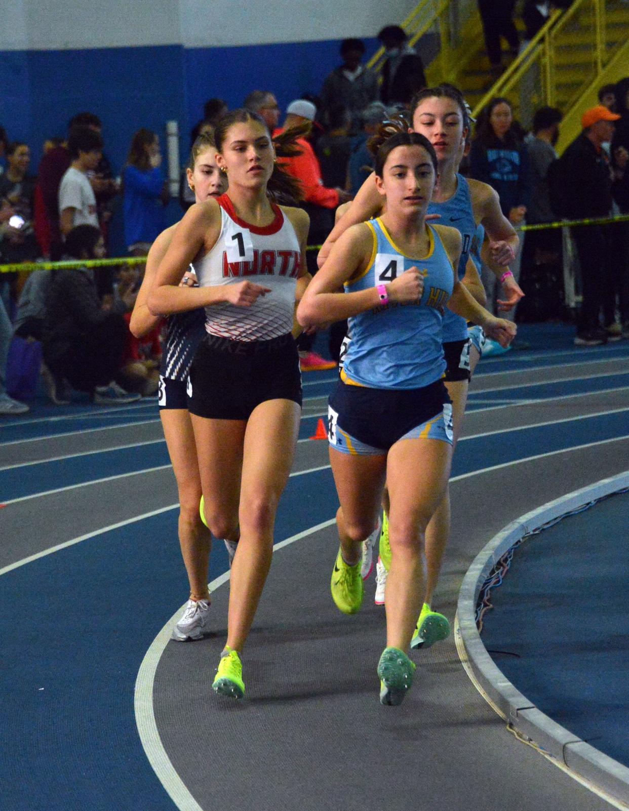 North Hagerstown's Lauren Stine (1) and River Hill's Lauren Virmani race side by side during the Class 3A girls 3,200 during the MPSSAA Indoor Track & Field Championships. Stine won in 11:03.58, with Virmani second in 11:07.93.