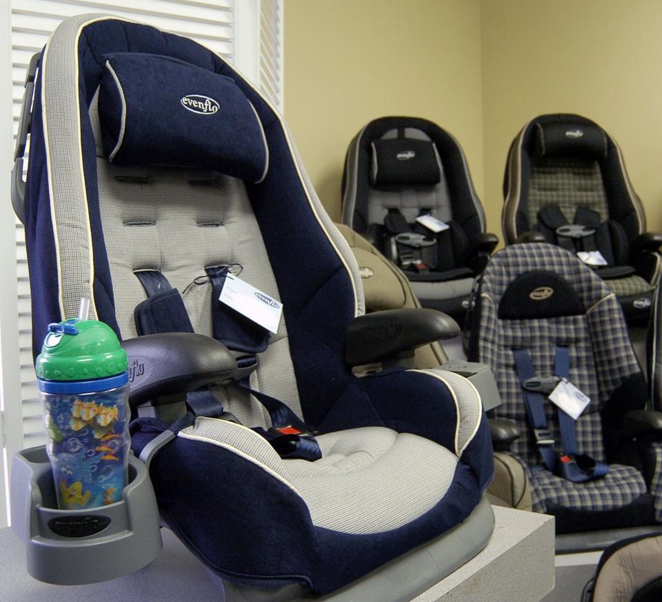 An Evenflo Co. car seat equipped with a built-in cup holder sits inside the company's showroom on Feb. 9, 2005, in Vandalia, Ohio. As more states push 4- to 8-year-olds back into safety seats, manufacturers also have added padding, neck pillows, snack holders and slots for toys.