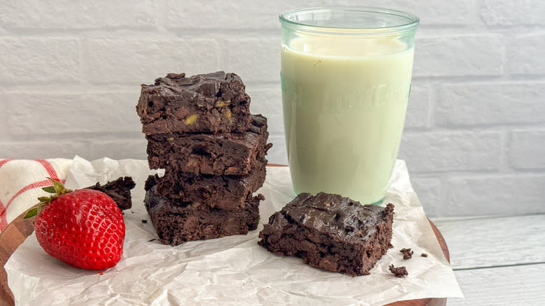 vegan brownies stacked with glass of milk