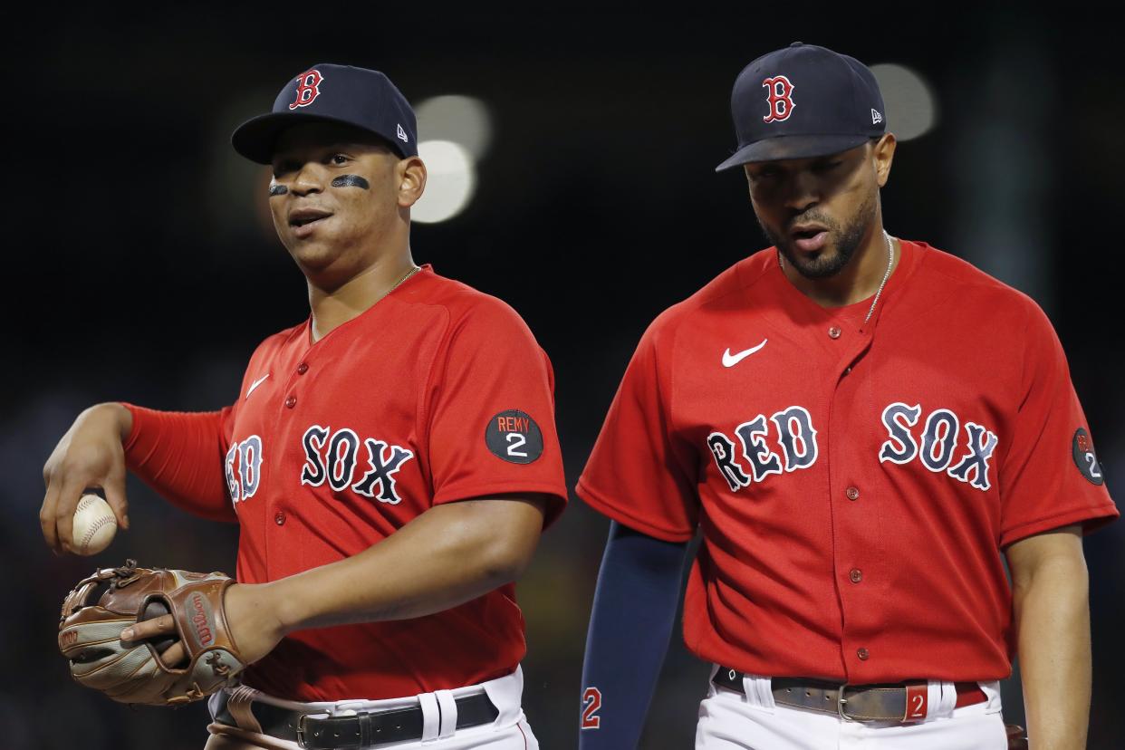 Boston Red Sox's Rafael Devers, left, and Xander Bogaerts walk to the dug out during the fourth inning of a baseball game against the New York Yankees, Friday, Aug. 12, 2022, in Boston. (AP Photo/Michael Dwyer)