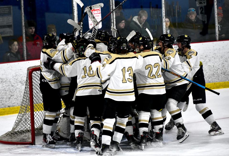 The celebration begins for the St. Paul boys' hockey team after defeating Marlborough for the Central Mass. Tournament Class A title.