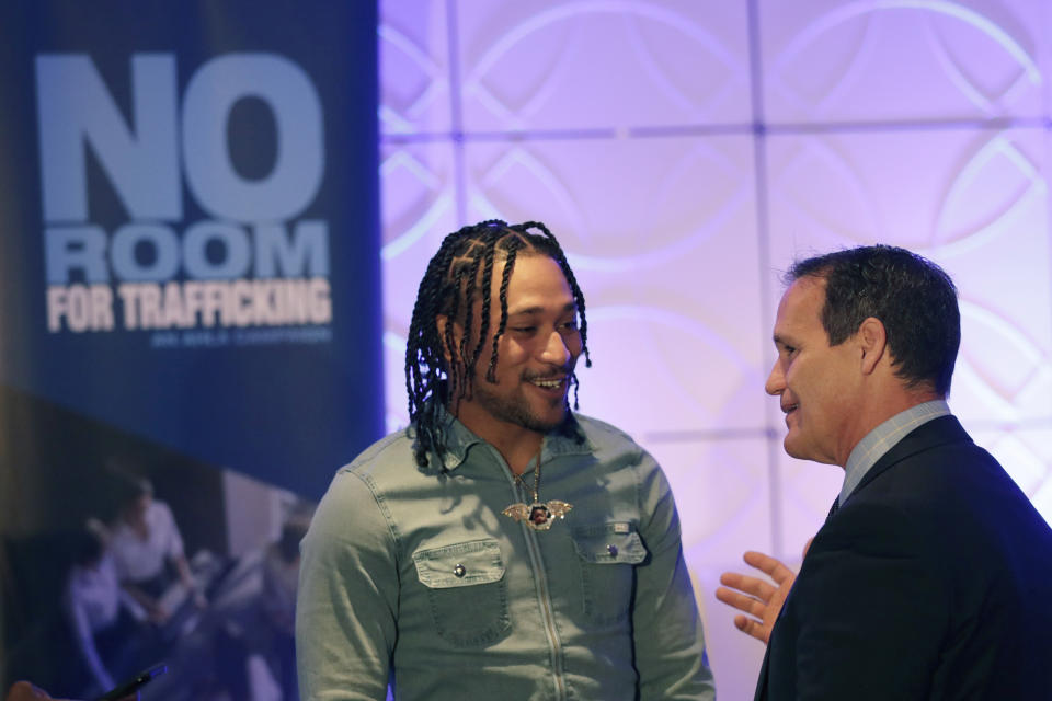 Miami Dolphins wide receiver Albert Wilson, left, speaks with Ray Martinez, executive director of the Miami Super Bowl Host Committee, during a meeting between law enforcement officials and hotel groups to announce a campaign to prevent human trafficking surrounding next month's Super Bowl football game in the Miami area, Thursday, Jan. 9, 2020, in Miami Beach, Fla. (AP Photo/Lynne Sladky)
