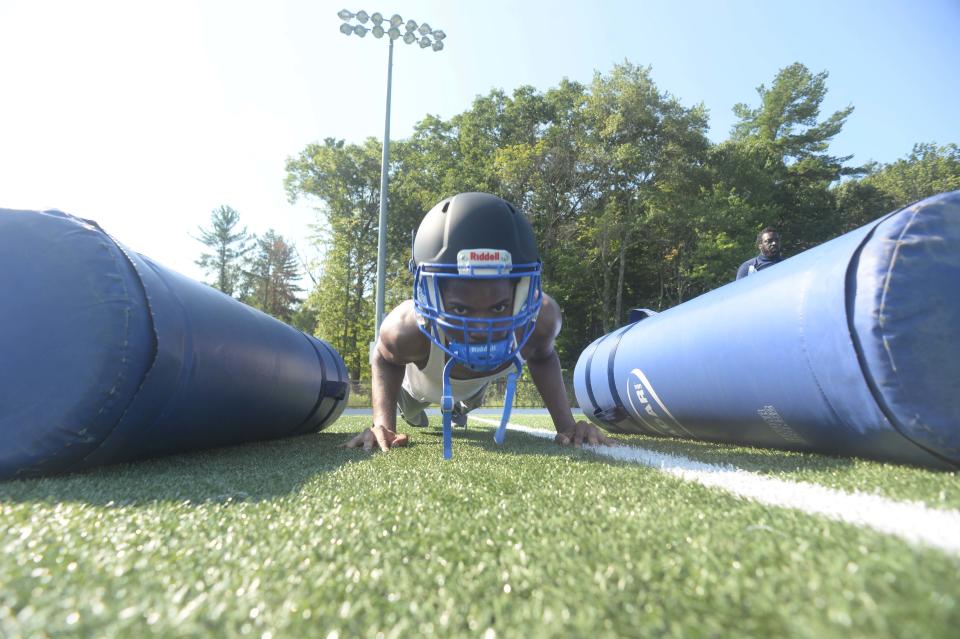 Rolens St. Jean doing pushups during the Holbrook/Avon football practice on Friday, August 26, 2022.  