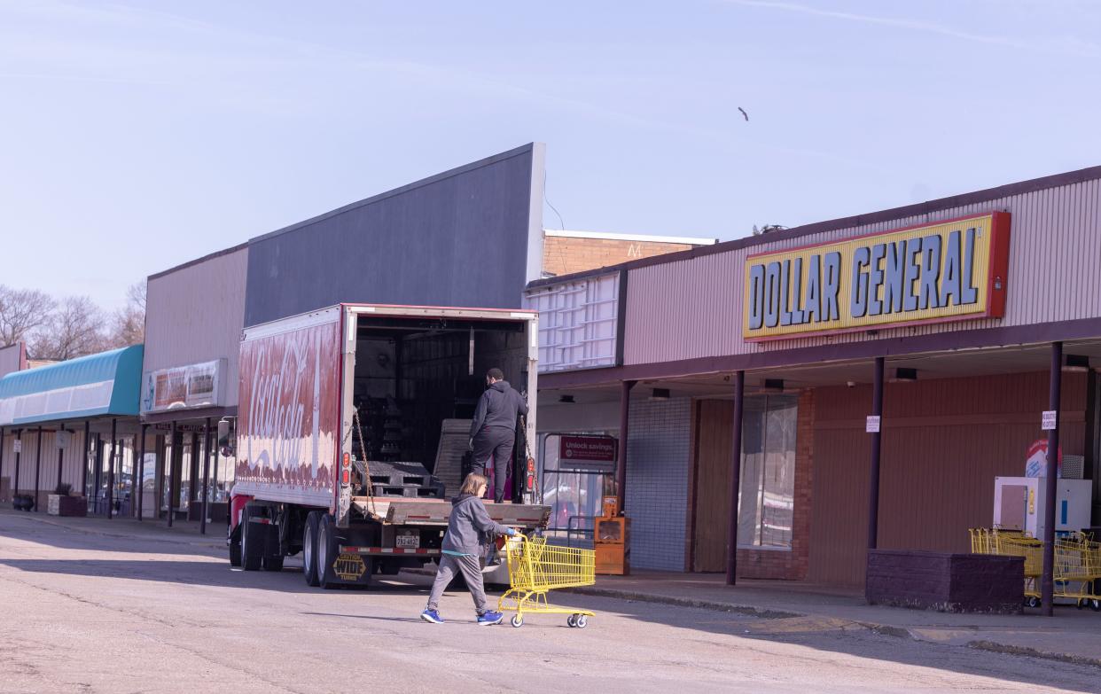 A woman enters the Dollar General at Meyers Lake Plaza in Canton Township. Rumors have circulated for months that MGM Resorts is buying the plaza. The owners say it's not true.