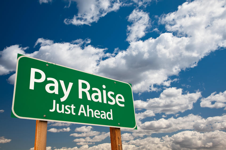 Sign saying pay raise just ahead.