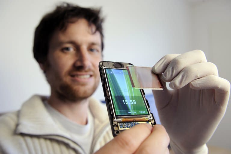 Company head Ludovic Deblois demonstrates Wysips's photovoltaic film in Lambesc, France in 2011. Wysips, a startup based in Aix-en-Provence, southern France, has developed a photovoltaic film which can be built seamlessly into a mobile phone screen and deliver the joy of life to a flat battery