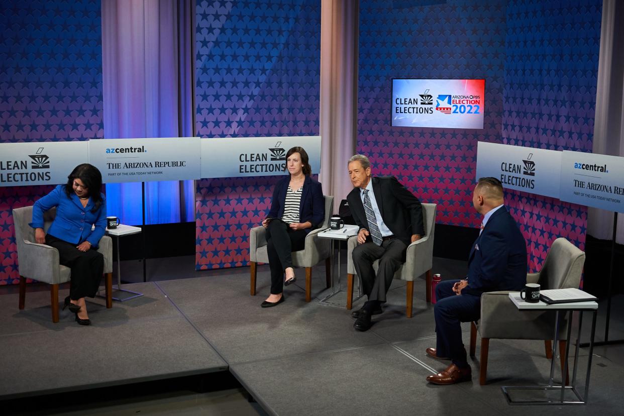 Kimberly Yee (left), Stacey Barchenger, Ted Simons and Martín Quezada (right) sit on stage minutes before beginning a debate between candidates for State Treasurer on Oct. 3, 2022.