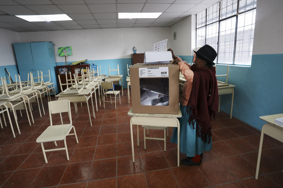 A voter casts her ballot in Cayambe, Ecuador, Sunday, Aug. 20, 2023. The election was called after President Guillermo Lasso dissolved the National Assembly by decree in May to avoid being impeached. (AP Photo/Dolores Ochoa)