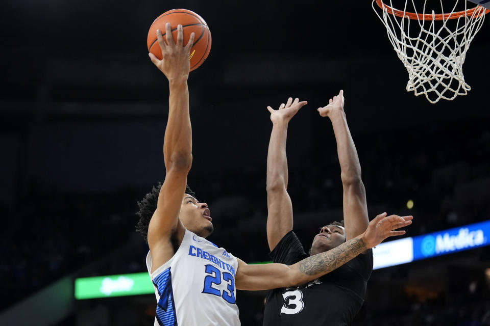 Creighton guard Trey Alexander (23) shoots over Xavier guard Dailyn Swain (3) during the first half of an NCAA college basketball game, Tuesday, Jan. 23, 2024, in Omaha, Neb. (AP Photo/Charlie Neibergall)